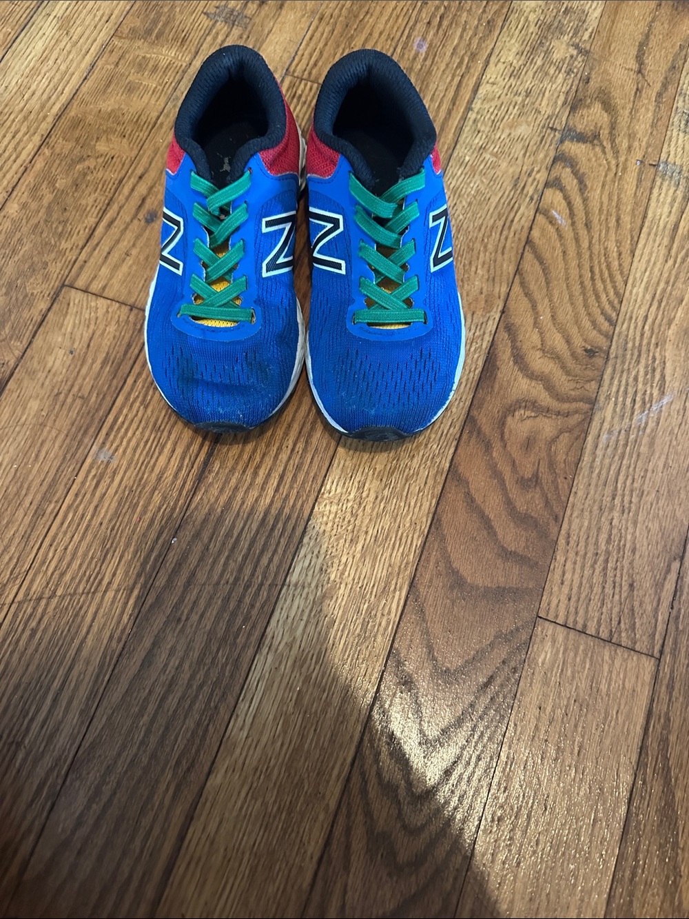New Balance Kids Blue Sneakers with Red and Green Accents